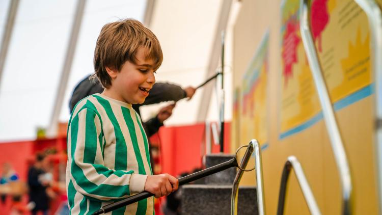 Boy using buzz wire game