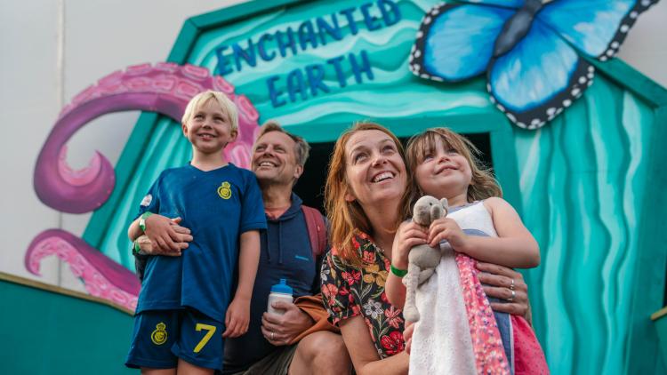 Family standing in front of an Enchanted Earth doorway
