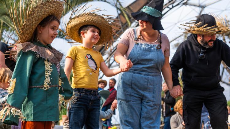 Family stood in Biome wearing scarecrow costumes